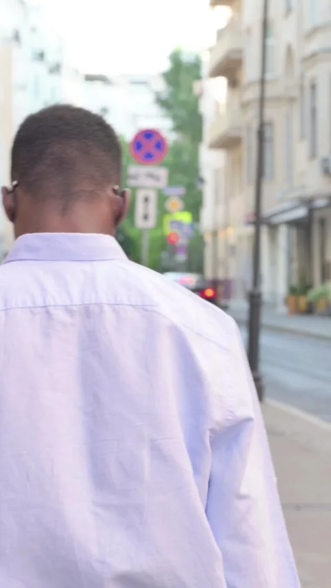 Back View of African Man Walking on the Street, Vertical Video Stockbeeldmateriaal 340022272