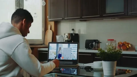 Back view of african man watching online video conference on computer and making Stock Footage 131537980