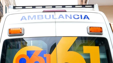 Back view of an ambulance with two orange lights flashing. Video stock 106342951