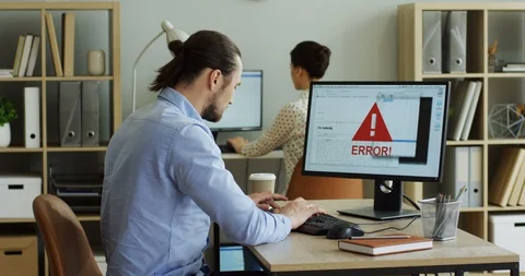Back view on the angry nervous man coping with a broken computer with an error Stock-Footage 91602733