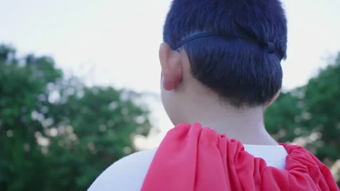Back view of Asian boy playing paper rocket in the park Stock Footage 173355720