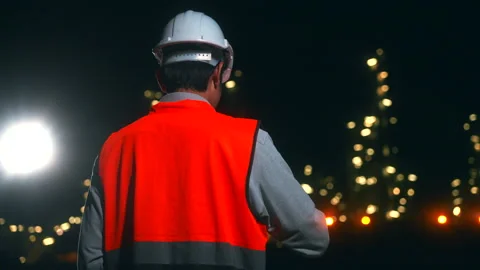 Back view of Asian man engineer working with tablet and walkie talkie. Stock Footage 270461745