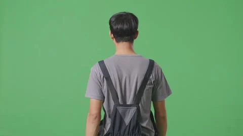 Back View Of Asian Man Worker Walking In The Green Screen Background Studio Stock Footage 253467318