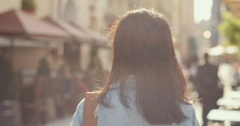 Back view on the Asian stylish young woman walking the city street as a tourist Stock Footage 111447695