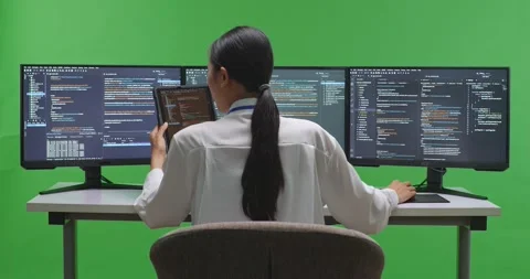 Back View Of Asian Woman Developer Working With Tablet While Write Code With Stock Footage 231133055