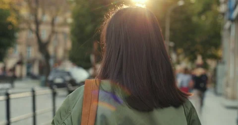 Back view on the Asian young pretty brunette woman in glasses and with red lips Stock Footage 111450301