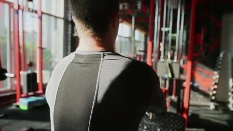 Back view of athletic man exercising on seated low row machine at gym Vídeo Stock 143521772