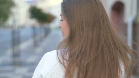 Back view of attractive long-haired curly brunette woman Stock Footage 140361281