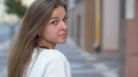 Back view of attractive long-haired curly brunette woman Stock Footage 140361283