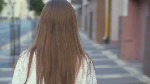 Back view of attractive long-haired curly brunette woman Stock Footage 140361390