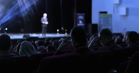 Back view of the audience sitting at a business conference. Speaker is holding a Stock Footage 168048833