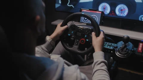 Back view of A bearded man using a driving simulator Video stock 258385203