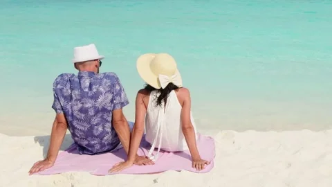 Back view beautiful authentic tourist couple wear hats sit on tropical beac.. Stock Footage 278306250