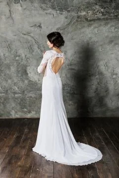 Back view of beautiful brunette bride with perfect makeup and hair style Stock Photos