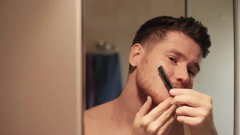 Back view from behind male reflection in mirror in bathroom naked young man Stock Footage 246154327