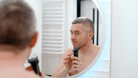 Back view from behind male reflection in mirror in bathroom naked guy Stock-Footage 259637400