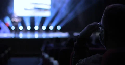 Back view between the rows of the audience sitting at a business conference Stock Footage 168048773