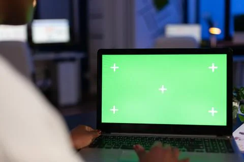 Back view of black business woman using laptop with green screen Stock Photos