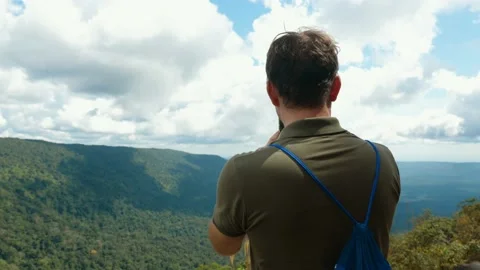 Back view of blogger or vlogger recording video or shooting photo on smartphone Stock Footage 167170865