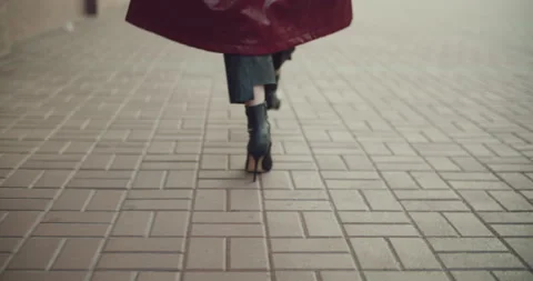 Back view of blond high-heeled woman walking through an empty city center Stock Footage 158298144
