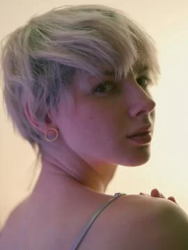 Back view of blonde looking at camera Stock Photos