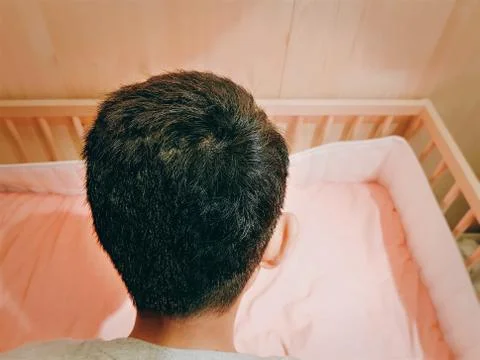 Back View of a Boy Preparing a Bed for New Family Member Stock Photos