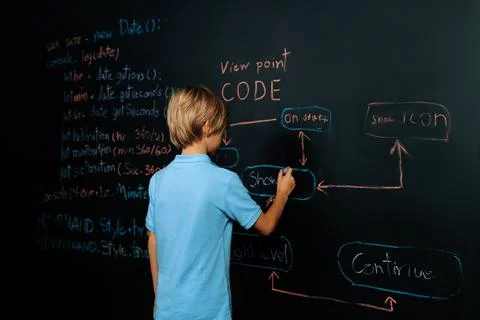 Back view of boy write code on blackboard while stand and thinking. Erudition. 스톡 사진
