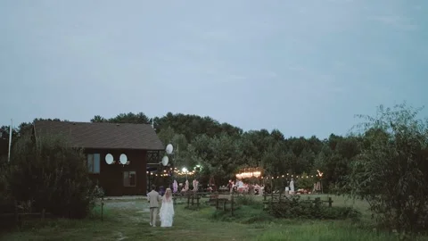 Back view of bride and groom walk to the wedding party. Bride in boho style Vidéo 227881620