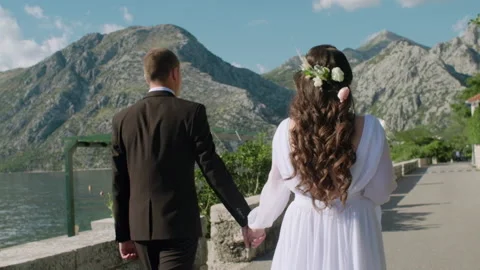 Back view of bride in beautiful white dress and groom Stock Footage 131001631