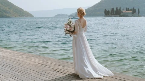 Back view of bride with Tender wedding bouquet of cream roses  flower Stock Footage 90870813