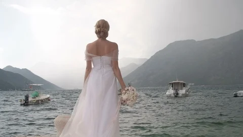 Back view of bride with Tender wedding bouquet of cream roses Stock Footage 98581487