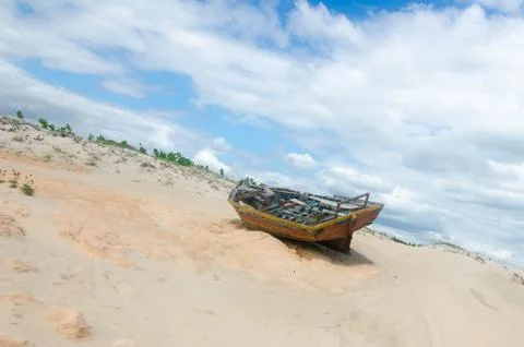 Back view of a broken canoe over the sand Stock Photos