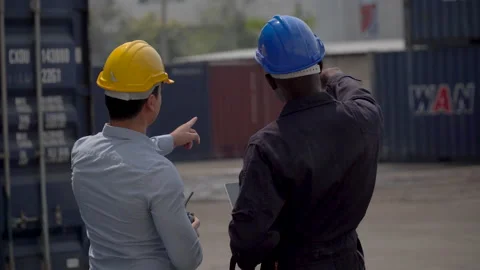 Back view of business man and african american foreman using laptop  checking Stock Footage 154690567
