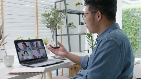 Back view of business man talking about sale report in video conference Stock Footage 139748849