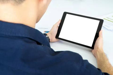 Back view of Business man using tablet with black screen in office Photos