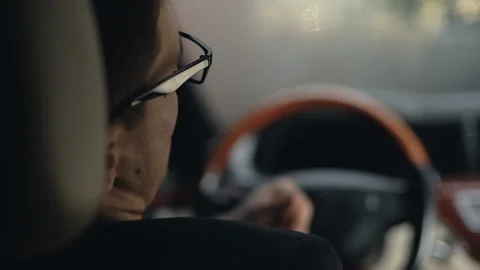 Back view of businessman drinking alcohol in car before driving home, problems Stock Footage 98762002