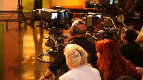 Back view of cameramans and spectators in big TV studio during filming Stock Footage 981019