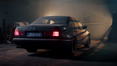 Back view classic BMW sedan, bathed in soft glow of lights, stands alone in Stock Footage 279852955