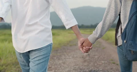 Back view. Close-up of hand Asian families holding to hand and enjoying nature Stock Footage 135249199