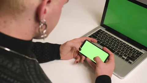 Back view. Close up homosexual man with a manicure use laptop green screen Stock Footage 146906705