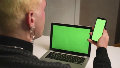 Back view. Close up homosexual man with a manicure using laptop green screen Stock Footage 146907016
