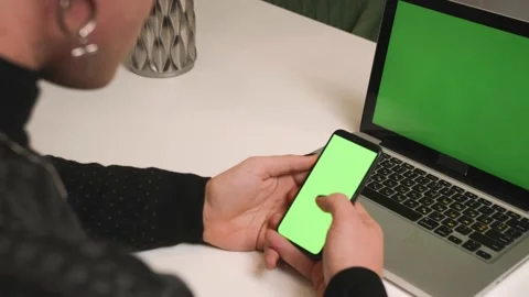 Back view. Close up homosexual man with a manicure use laptop green screen Video stock 146907290