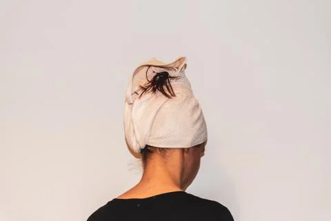 A back view close-up portrait of a young Caucasian woman after shower with he Stock Photos