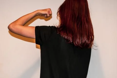 A back view close-up shot of a strong unrecognizable young Caucasian redhead  Stock Photos