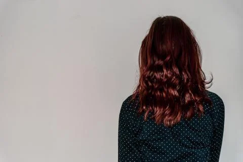 A back view close-up shot of an unrecognizable young Caucasian redhead woman  Stock Photos