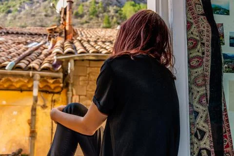 A back view close-up shot of an unrecognizable young Caucasian redhead woman  Stock Photos