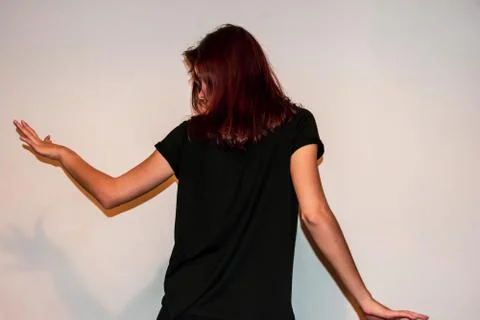 A back view close-up shot of an unrecognizable young Caucasian redhead woman  Stock Photos