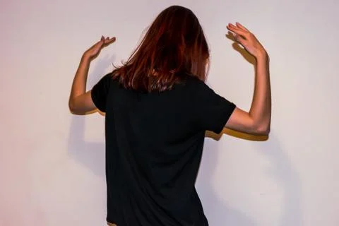 A back view close-up shot of an unrecognizable young Caucasian redhead woman  Stock Photos