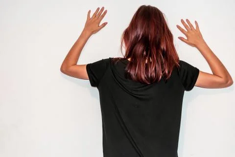 A back view close-up shot of an unrecognizable young Caucasian redhead woman  Stock Photos