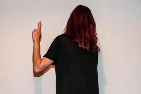 A back view close-up shot of an unrecognizable young Caucasian redhead woman  Stock Photos